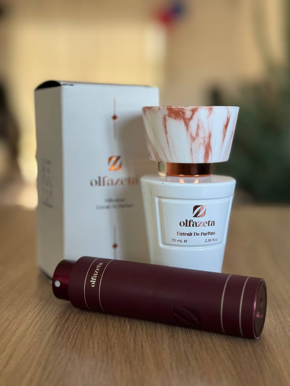 Flacon Olfazeta Extrait de Parfum 70 ml, blanc au bouchon marbré, et son vaporisateur de voyage